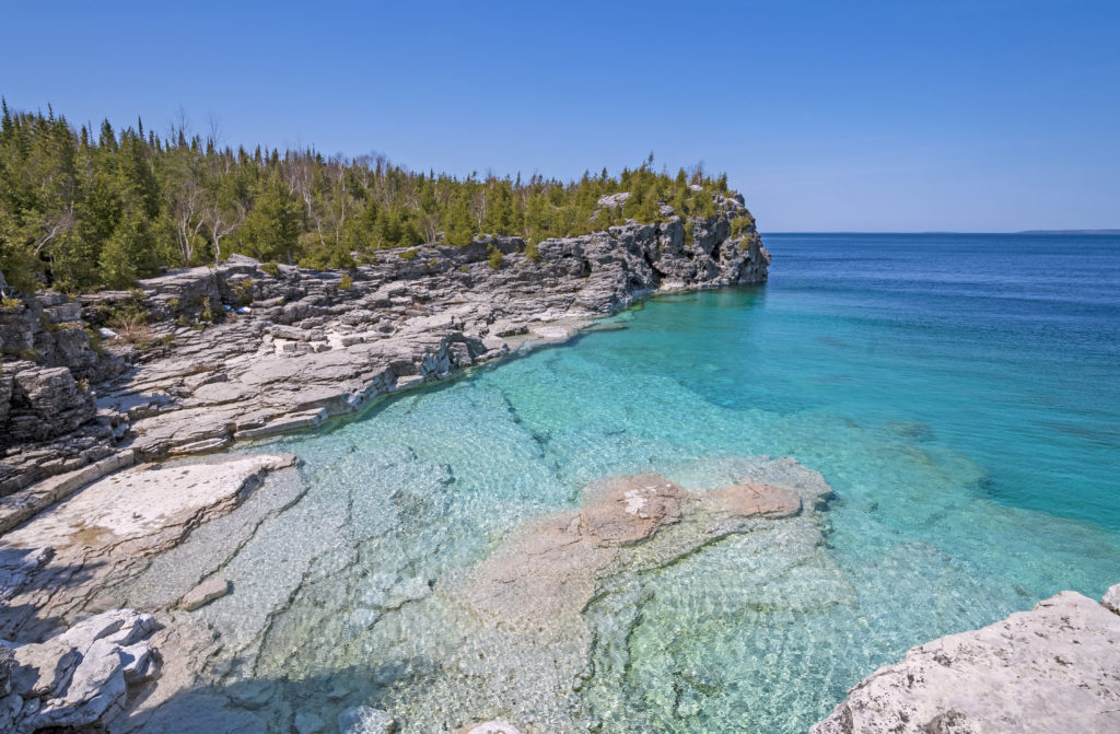 Clear Waters in a Gray Cliffed Cove at Indian Cove in Bruce Peninsula National Park in Ontario